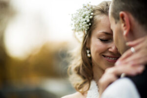 beautiful couple enjoying embrace of each other and tenderly smiling