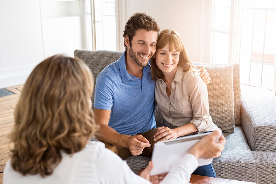 Happy young man and woman consulting plans digital PC real estate apartment
