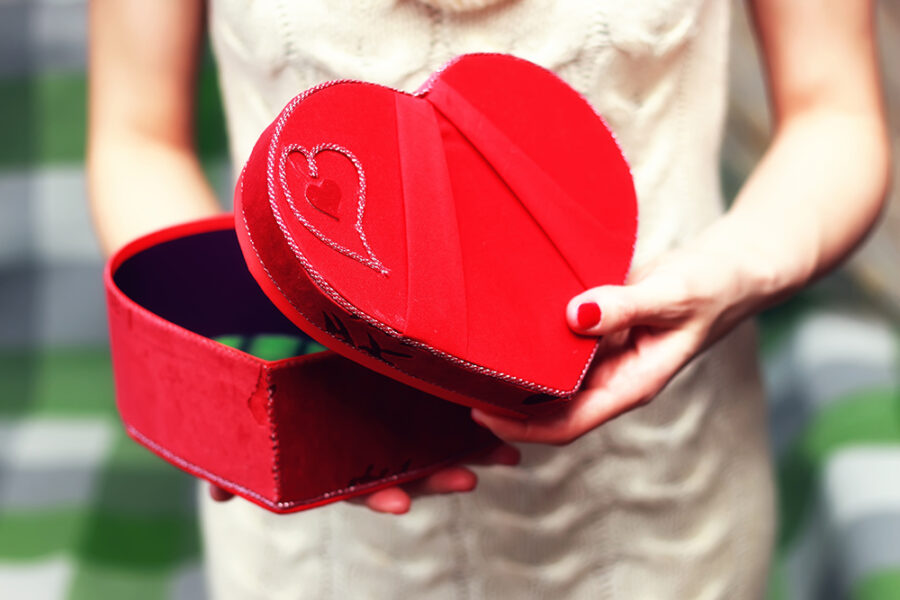 girls hand holding valentine heart shape box
